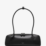 Black handbag with a bow detail on a white background