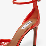 Red studded fishnet pumps