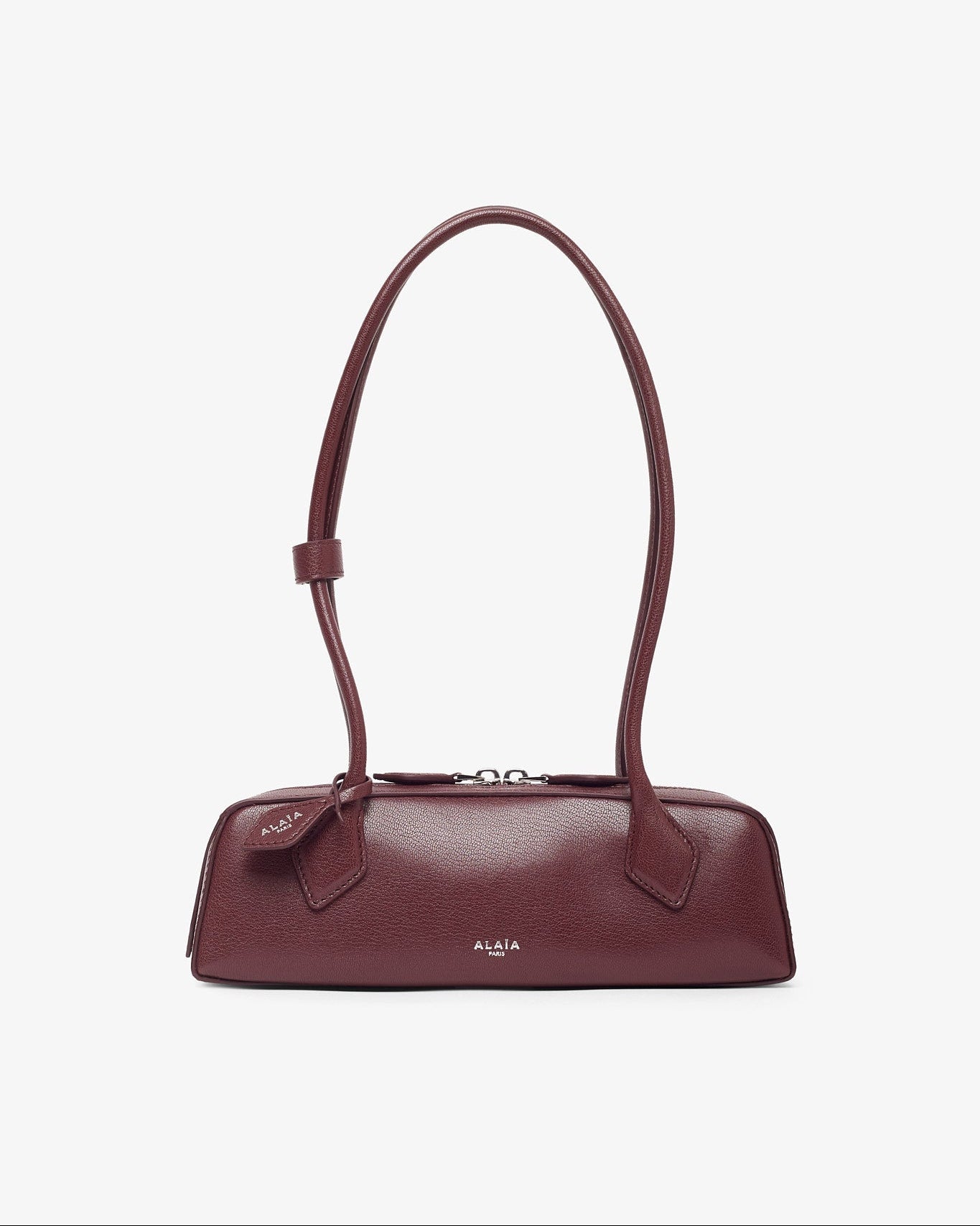 Maroon handbag on a light beige background