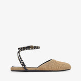 Beige flat sandal with studded detail on a white background