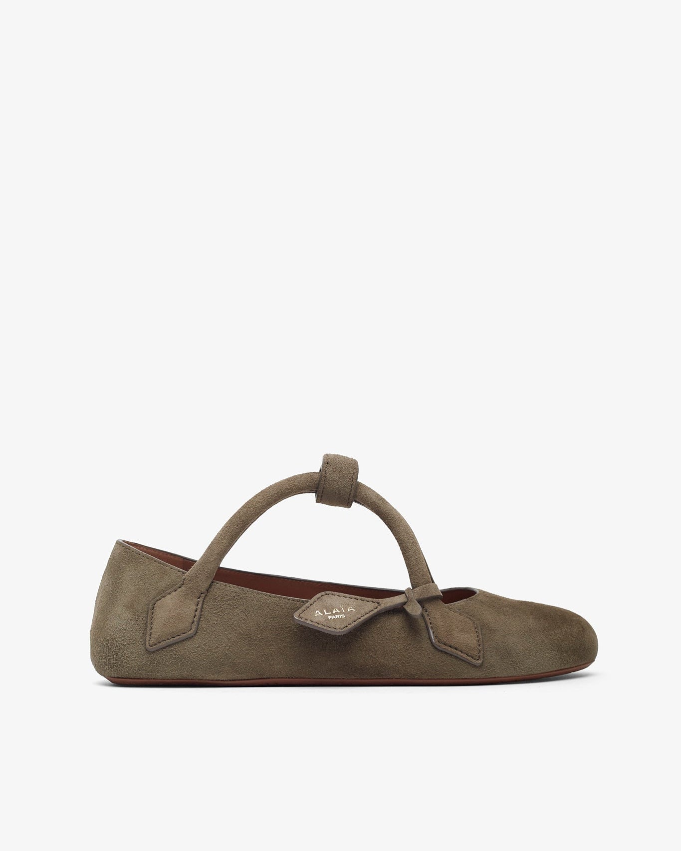 Brown suede ballerina shoe with a strap on a white background