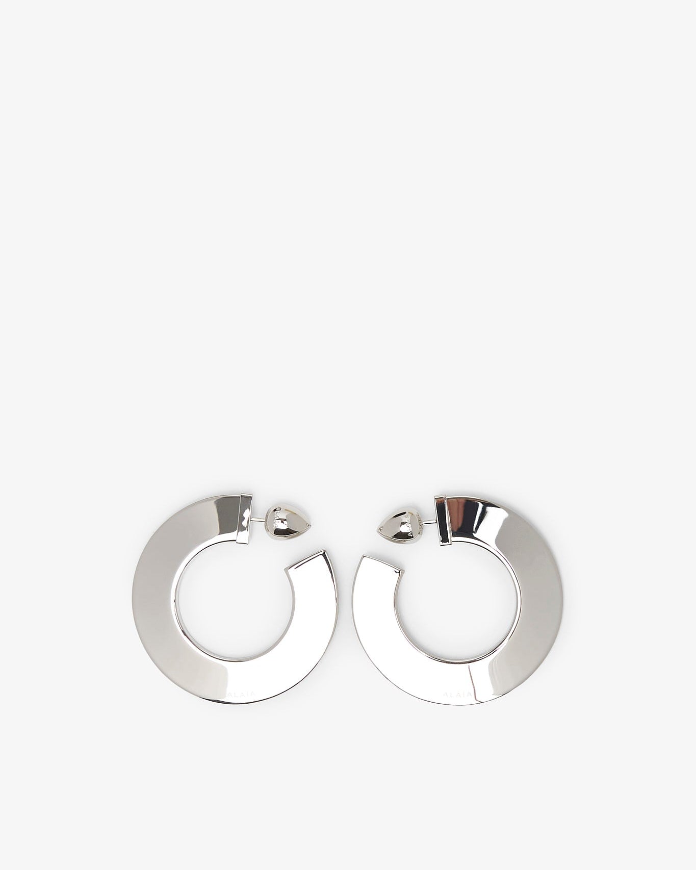 Pair of silver hoop earrings on a white background