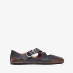 Brown leather shoe with a strap on a white background