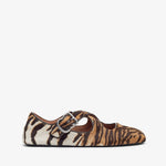 Zebra print shoe with a buckle on a white background