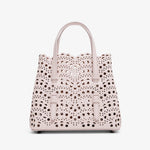 Handbag with a polka dot pattern on a white background