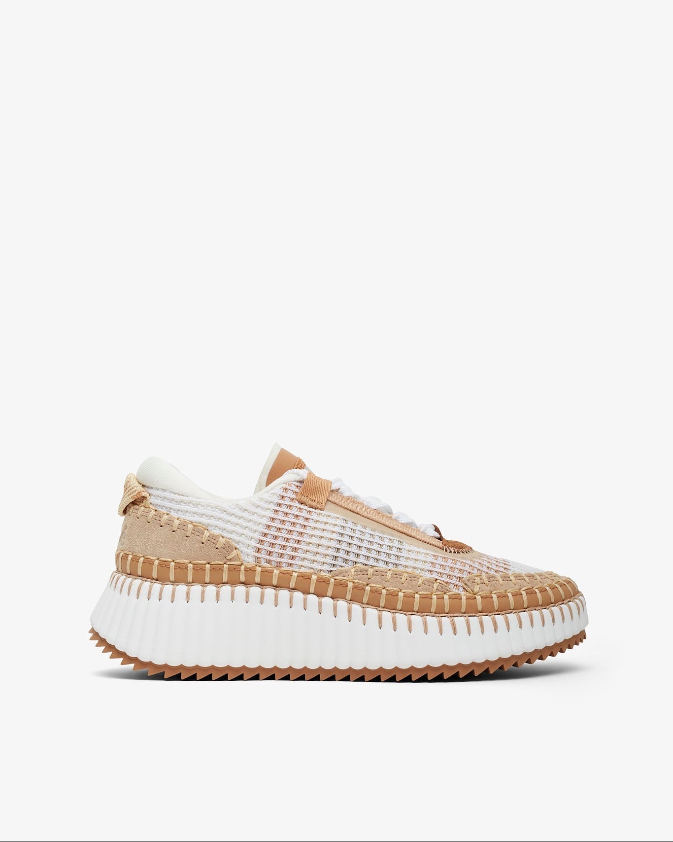 Sneaker with white sole and beige mesh upper on a white background