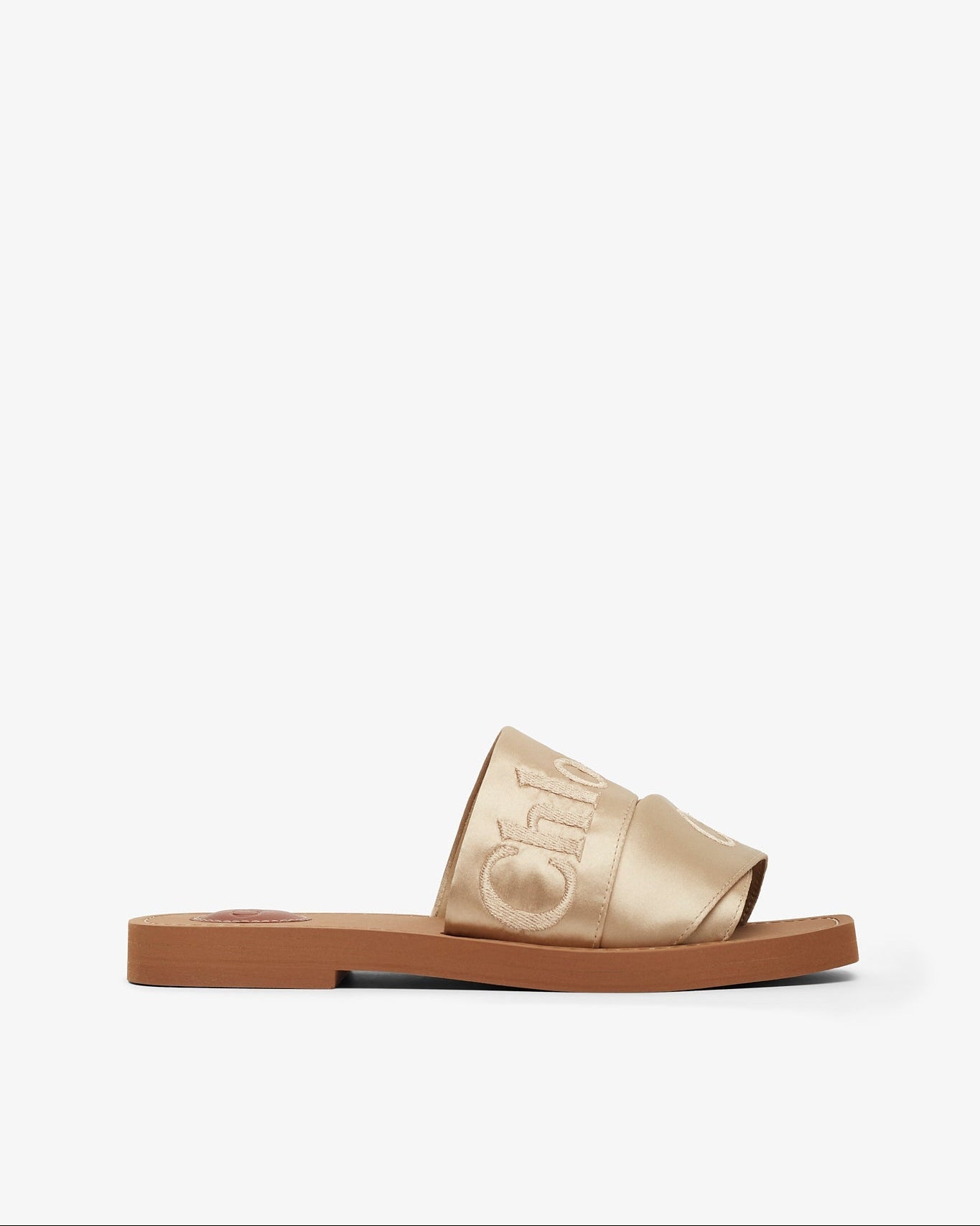 Gold slide sandal with brand logo on a white background