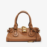 Brown handbag with gold accents on a white background
