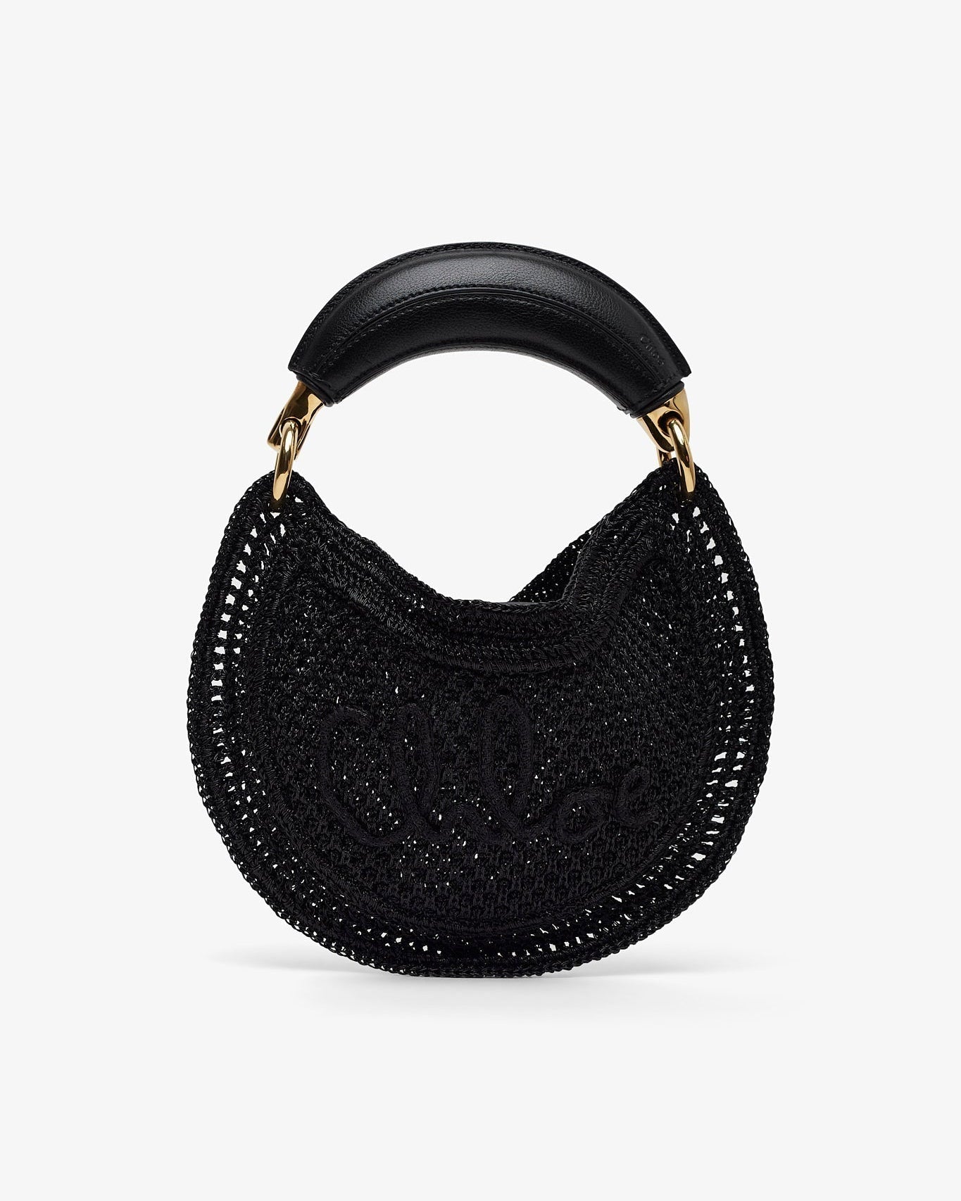Black woven handbag with a gold handle on a white background