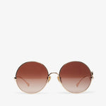 Round sunglasses with a gradient brown lens on a white background