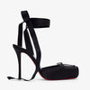 Black high-heeled shoes with ribbon straps on a white background