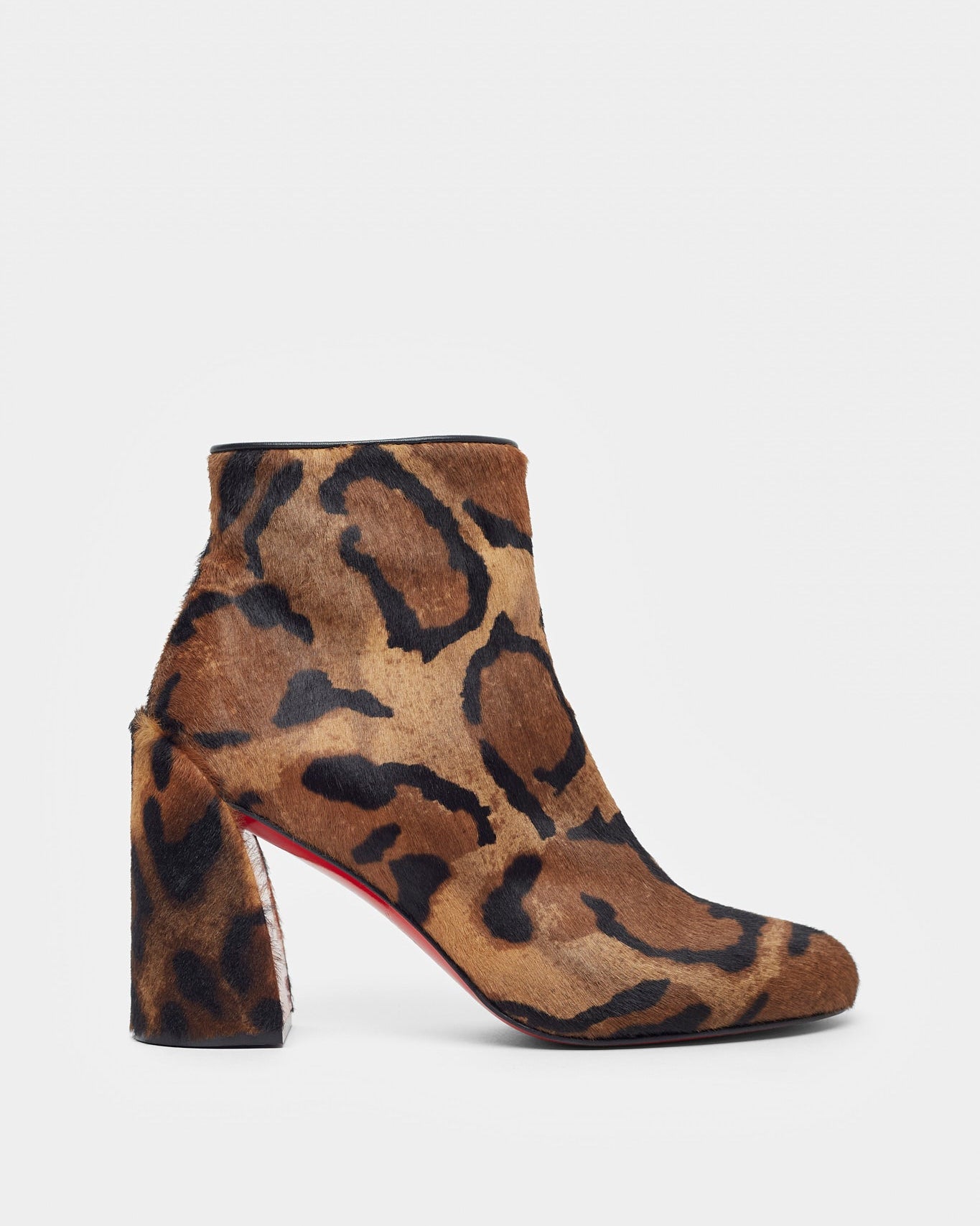 Leopard print ankle boot with a block heel on a white background