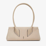 Beige handbag with unique handle design on a white background