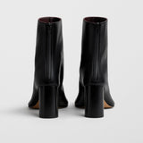 Tug black leather ankle boots