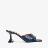 Navy blue high-heeled shoe with a subtle pattern on a white background