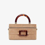 Beige handbag with tortoiseshell accents on a white background