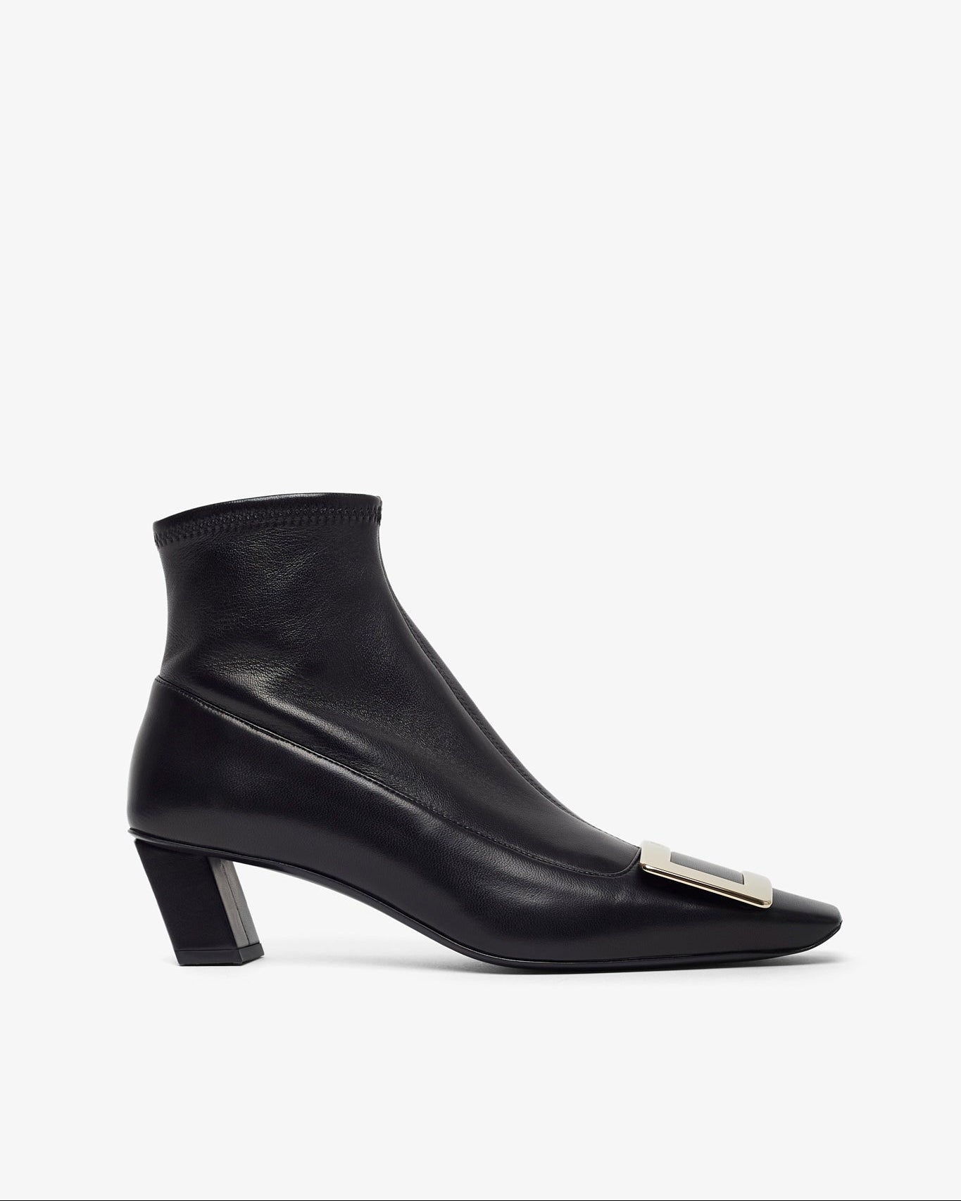 Black ankle boot with a small silver detail on a white background