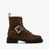 Brown suede boot with a silver buckle on a white background