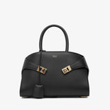 Black handbag with gold accents on a white background