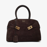 Brown handbag with gold hardware on a white background