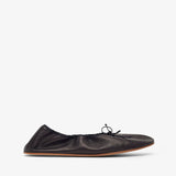 Black leather flat shoe on a white background