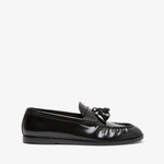 Black loafers with tassel on a white background