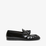 Black loafers with tassel on a white background