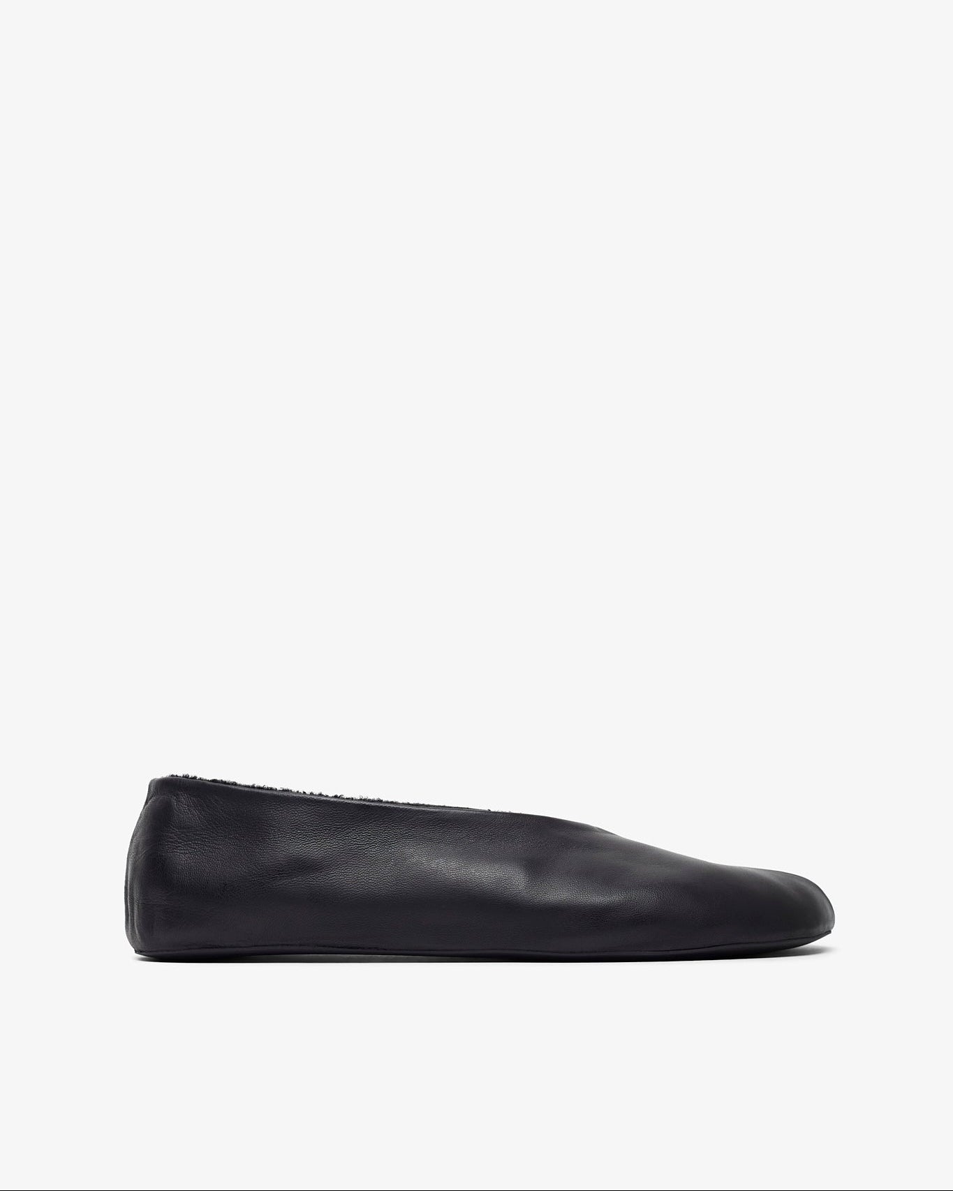 Black slip-on shoe on a white background