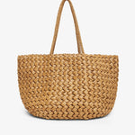 Woven straw tote bag on a white background