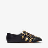 Black flat shoe with gold buckles on a white background
